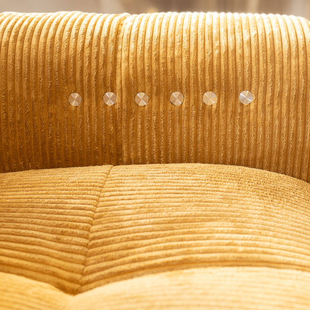 Detail du dossier en velours cotele jaune moutarde avec boutons metalliques decoratifs.