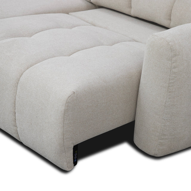 sofa modulaire en tissu gingembre, mécanisme coulissant sur fond blanc.