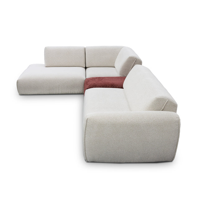 sofa modulaire en tissu crème marbré et tissu bordeau, au design contemporain sur un fond blanc.