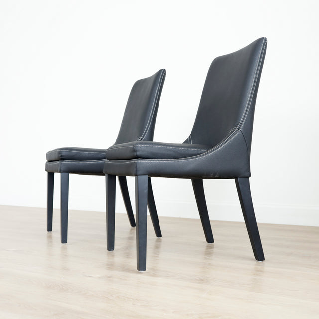 chaises de salle a manger noires au design moderne sur pieds en bois.