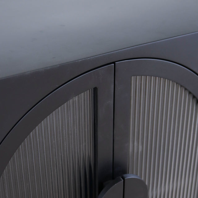 Buffet noir moderne a portes arquées en verre strie.