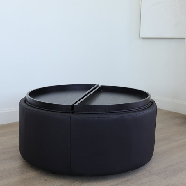 Ottoman avec plateau amovible en bois noir et base rembourrée, idéale pour salon moderne et fonctionnel.
