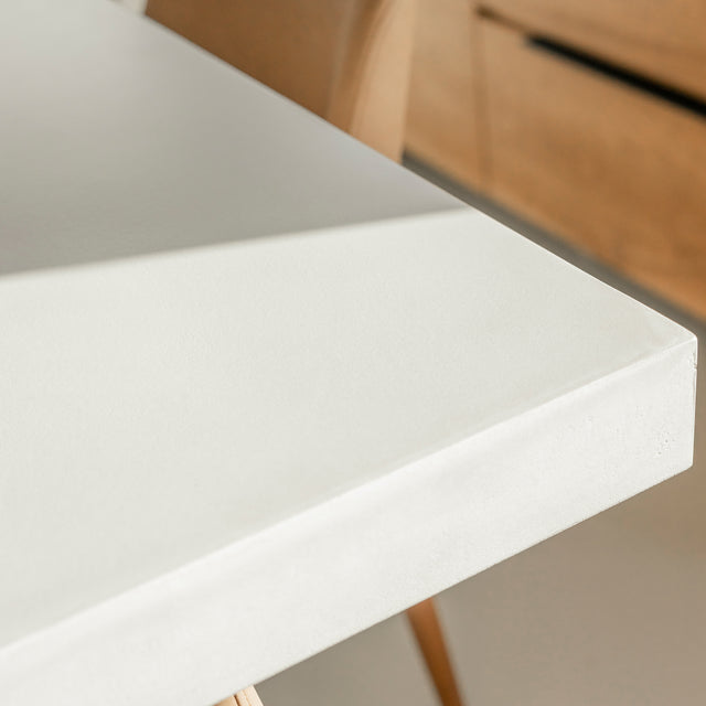 coin de table en beton blanc avec base en bois clair et finition lisse.