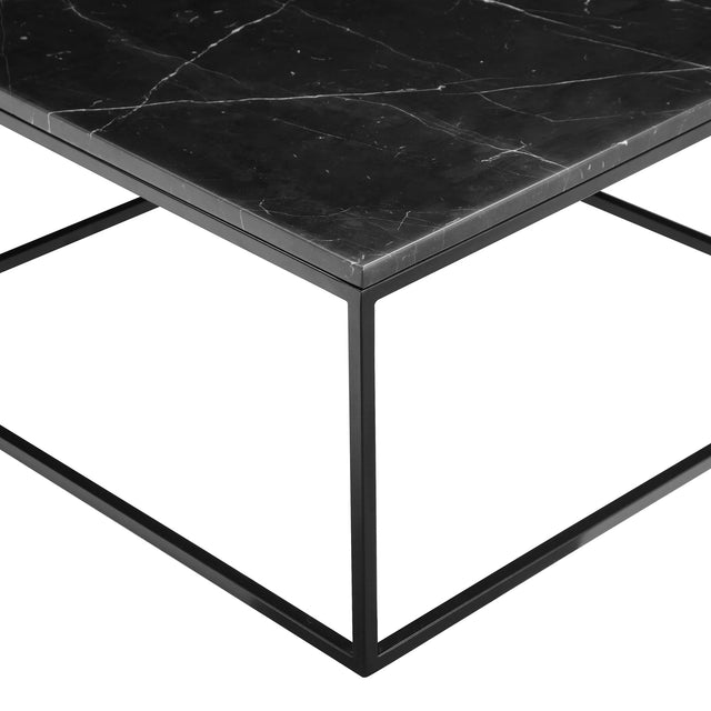 Table basse moderne avec plateau noir effet marbre et structure fine en metal noir.