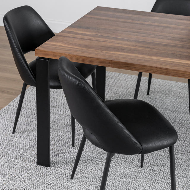 Table en bois noyer avec chaises noires