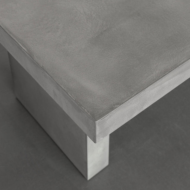 coin de table en beton gris au design industriel et finition lisse.