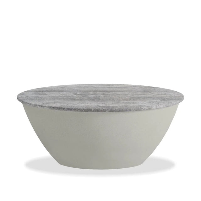 Table basse ronde en beton clair avec plateau effet pierre naturelle beige grisee.