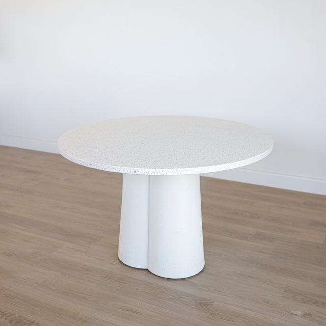 table ronde blanche au plateau en terrazzo et base sculpturale.