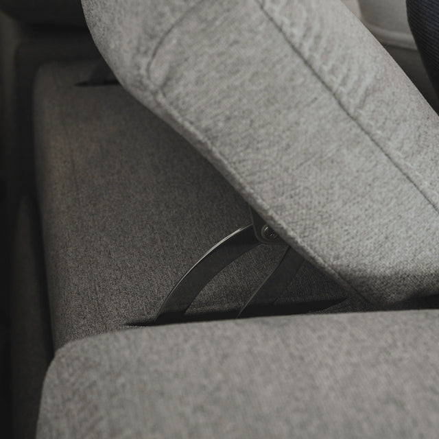 gros plan sur le mecanisme metallique de la tetiere reglable du canape gris clair.