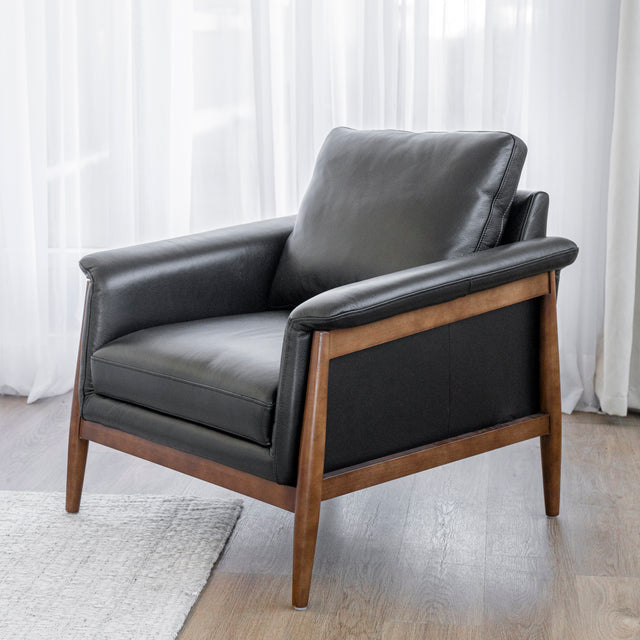 fauteuil en cuir noir avec structure en bois dans un salon moderne.