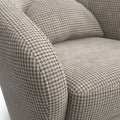 Fauteuil arrondi en tissu beige motif pied-de-poule, design contemporain sur fond neutre.