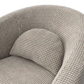Fauteuil arrondi en tissu beige motif pied-de-poule, design contemporain sur fond neutre.