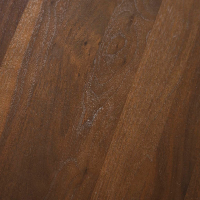 Image rapprochée d'une table ronde en noyer massif avec pied central croise au design contemporain.