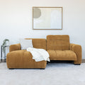Sectionnel en velours côtelé camel, design moderne avec assise large dans un salon minimaliste.