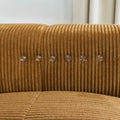 Sectionnel en velours côtelé camel, design moderne avec assise large dans un salon minimaliste.
