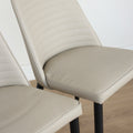 Deux chaises modernes taupe avec pieds noirs coniques, design elegant pour salle a manger.