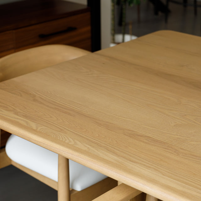 Salle à manger avec table en chêne massif et chaises design scandinaves.