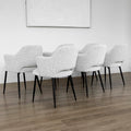 Lot de six chaises modernes en tissu boucle blanc avec pieds noirs elegants.