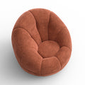Fauteuil design arrondi terracotta en tissu, sur fond neutre.