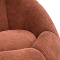 Fauteuil design arrondi terracotta en tissu, sur fond neutre.
