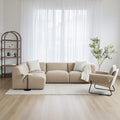 salon moderne avec un divan en cuir beige et un fauteuil en tissu beige.