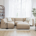 sofa modulaire beige avec un repose pied
