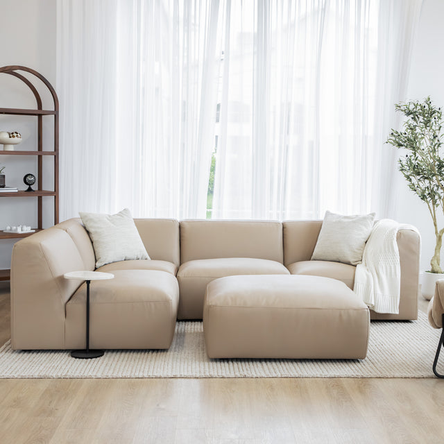 sofa modulaire beige avec un repose pied