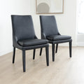 chaises de salle a manger noires au design moderne sur pieds en bois.