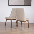 Ensemble de deux chaises en cuir beige avec pattes en bois teinture noyer
