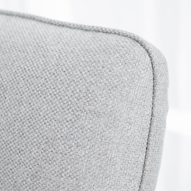 Modulaire inclinable moderne en tissu gris clair avec pieds metalliques noirs sur parquet clair.