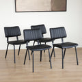 Quatre chaises noires en simili cuir avec pieds en metal, design moderne pour salle a manger.