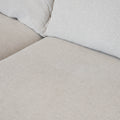 Modulaire deux morceaux, en tissu greige pale, avec méridienne droite, design moderne pour salon contemporain.