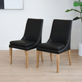 Lot de deux  chaises de salle à manger en cuir végane noir avec pattes en bois pâle, design moderne et élégant.