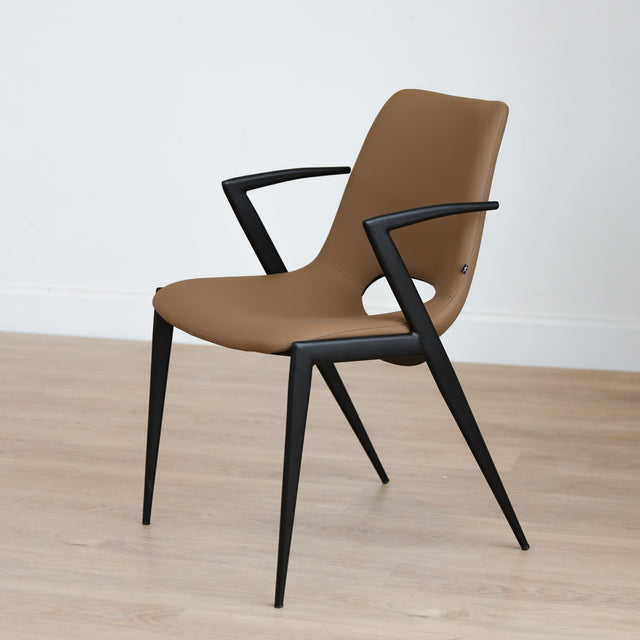 Chaise design en cuir végane Delta avec piètement noir et accoudoirs intégrés, idéale pour salle à manger moderne.