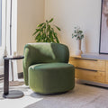 Fauteuil lounge vert en tissu bouclé avec base pivotante noire dans un salon moderne.