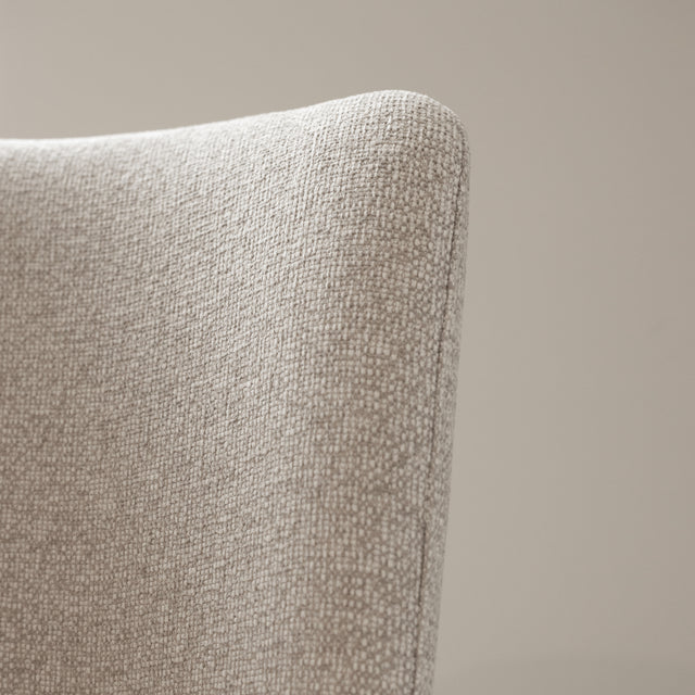 Tabouret de comptoir moderne en tissu beige avec piétement en métal noir, idéale pour cuisine ou îlot contemporain.