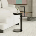 table d'appoint rond noir en metal au design minimaliste.