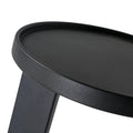 table d'appoint rond noir en metal au design minimaliste.