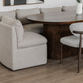 Table ovale en bois fonce avec banquette grise et chaise beige dans deco moderne.
