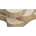 Table basse organique en bois clair à plateaux superposés, design sculptural pour salon contemporain.