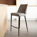 Tabouret de bar design avec assise en tissu brun/gris et pieds en metal noir, ideal pour cuisine moderne.